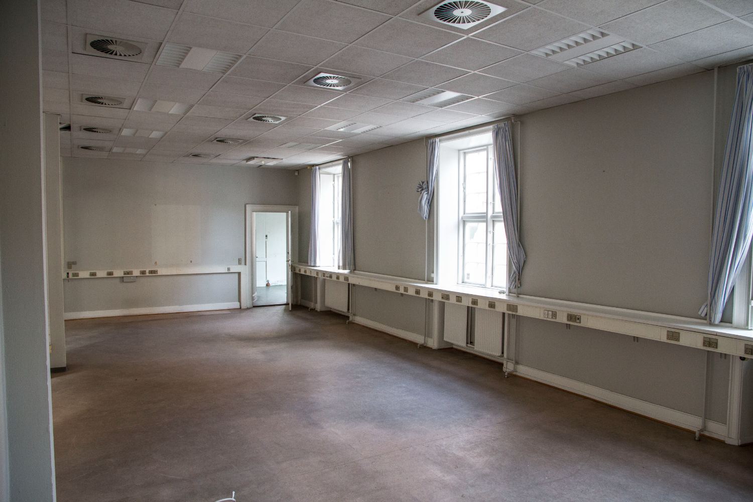Empty office with curtains and window desks