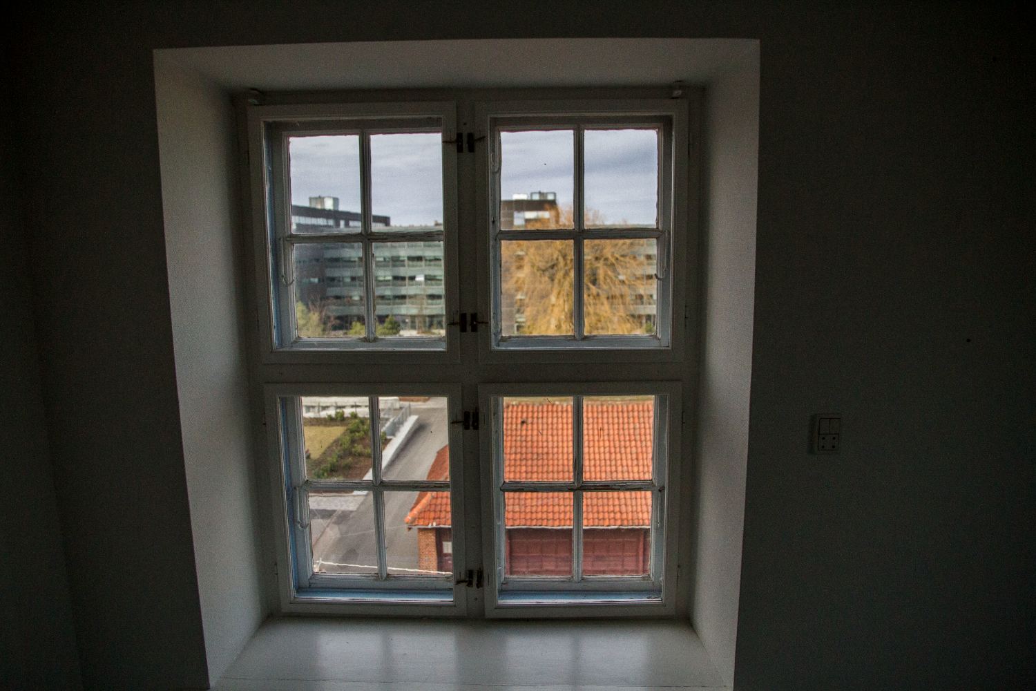 Window looking out over the tiled roofs